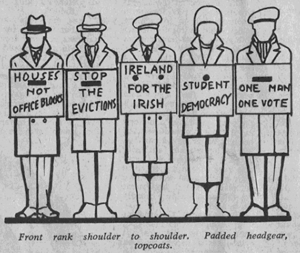 A cartoon of five figures wearing overcoats and hats each holding a placard. It is captioned, "Front rank shoulder to shoulder. Padded headgear, topcoats."