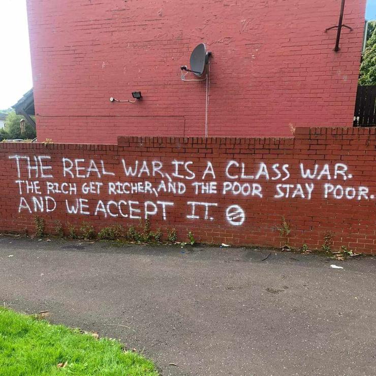 "The real war is a class war. The rich get richer and the poor stay poor. And we accept it" written on a wall with white spray paint